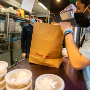 A restaurant adapts to the Covid-19 pandemic and stay at home orders by pivoting to take out and delivery.